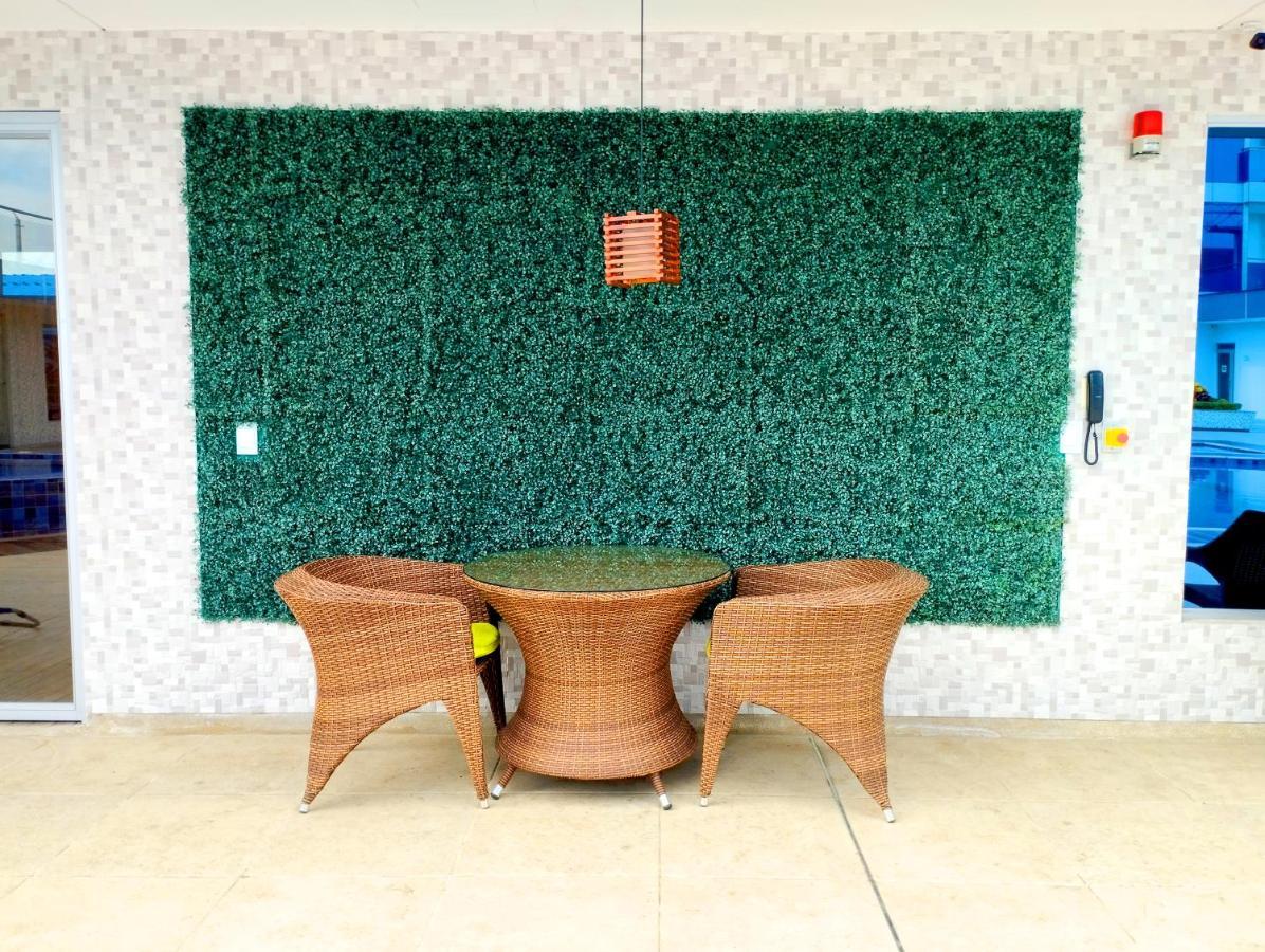 Hotel Royal Elim International Cali Exterior photo Artificial green wall