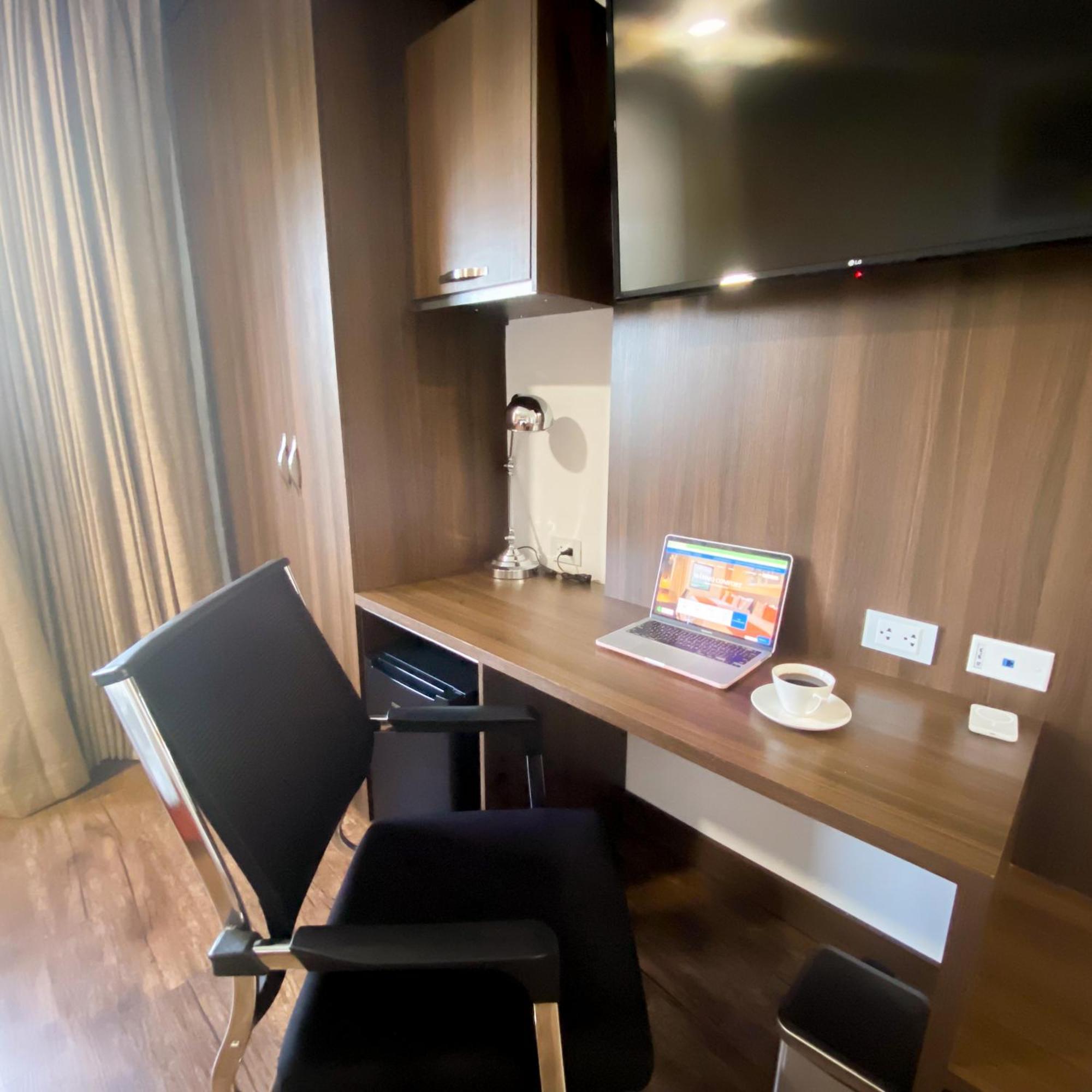 Hotel Royal Elim International Cali Exterior photo A work desk in a hotel room